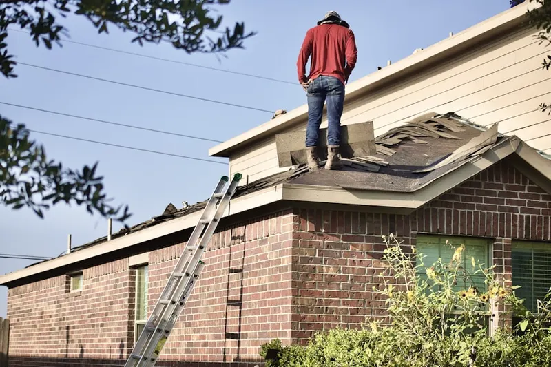 Professional roofer working on a residential roof in Herbst